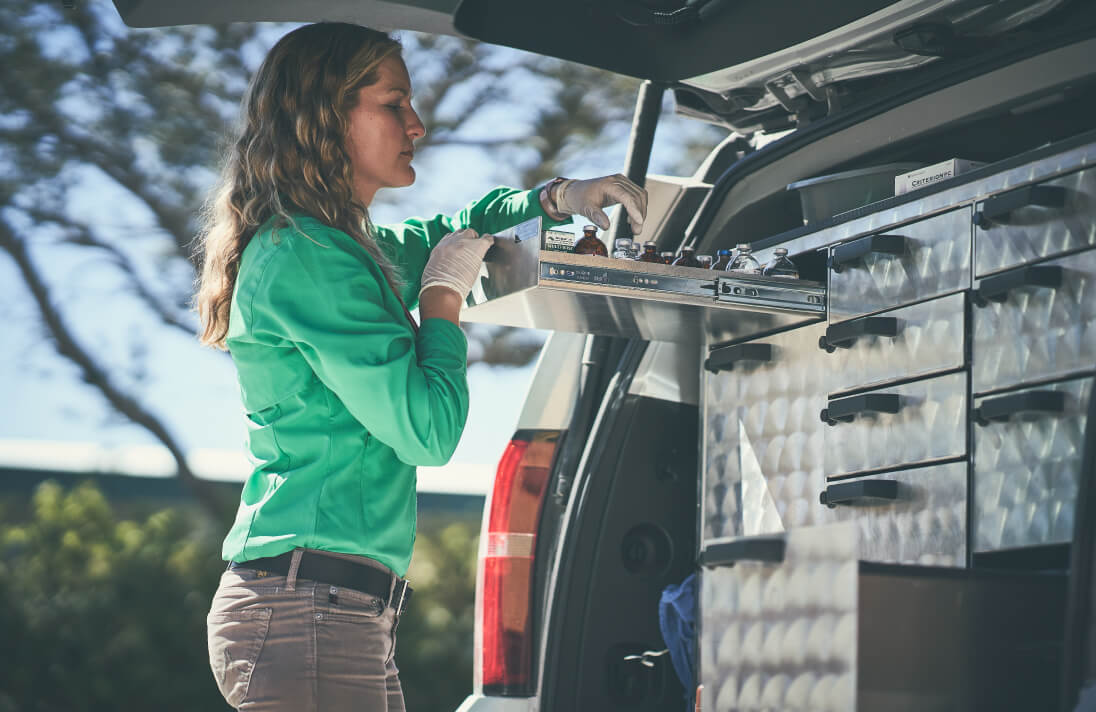 Vet reaching into a mobile vet unit