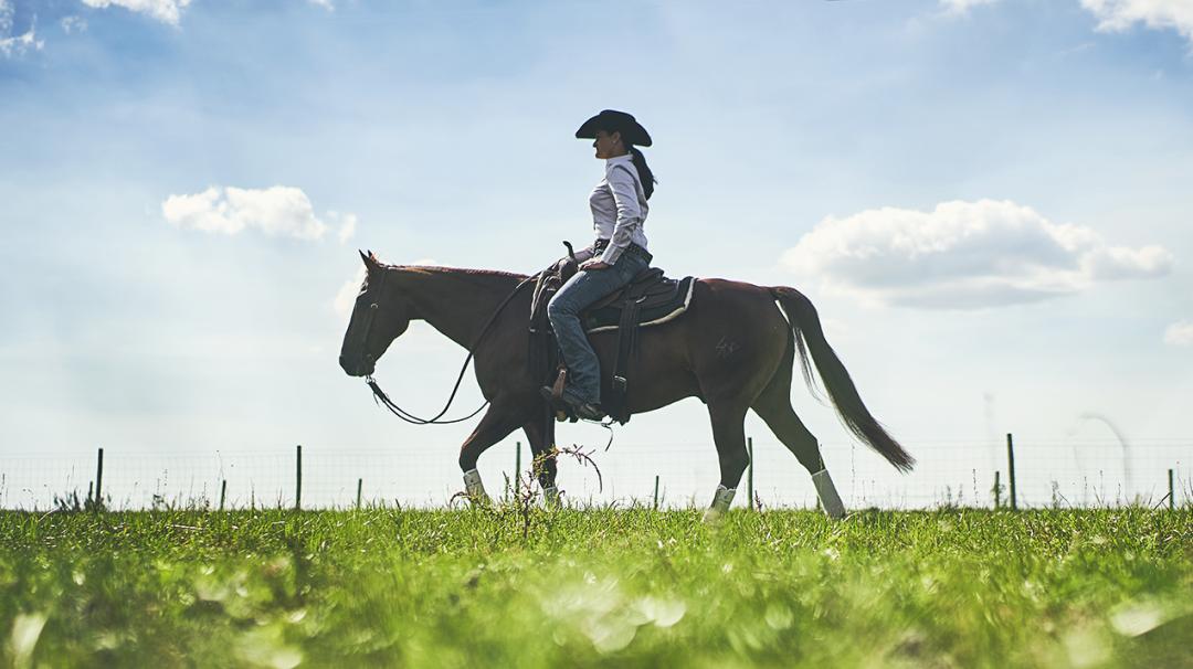 Woman riding a horse to symbolize equine deworming needs
